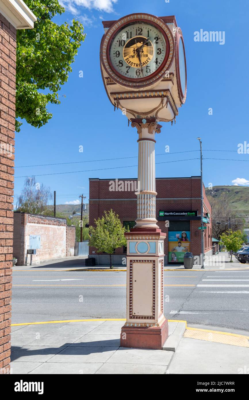 Okanogan, WA - USA-0511-2022: Antique Four Sided Town Clock on Pine Street. Live Better with Electicity Stock Photo