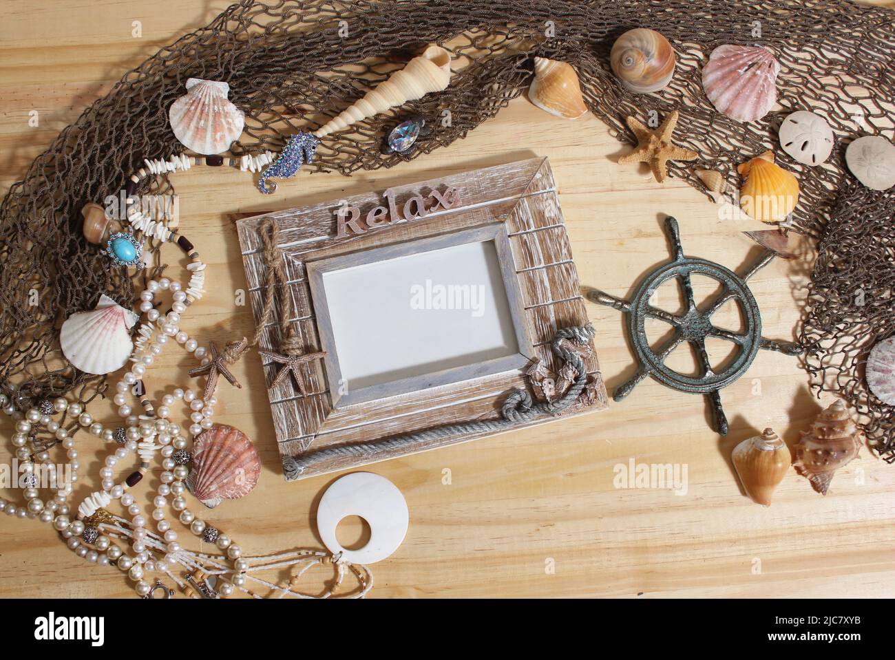 Empty Frame on Wood Background With Sea Shells and Fishing Net. Nautical and Coastal Theme Stock Photo