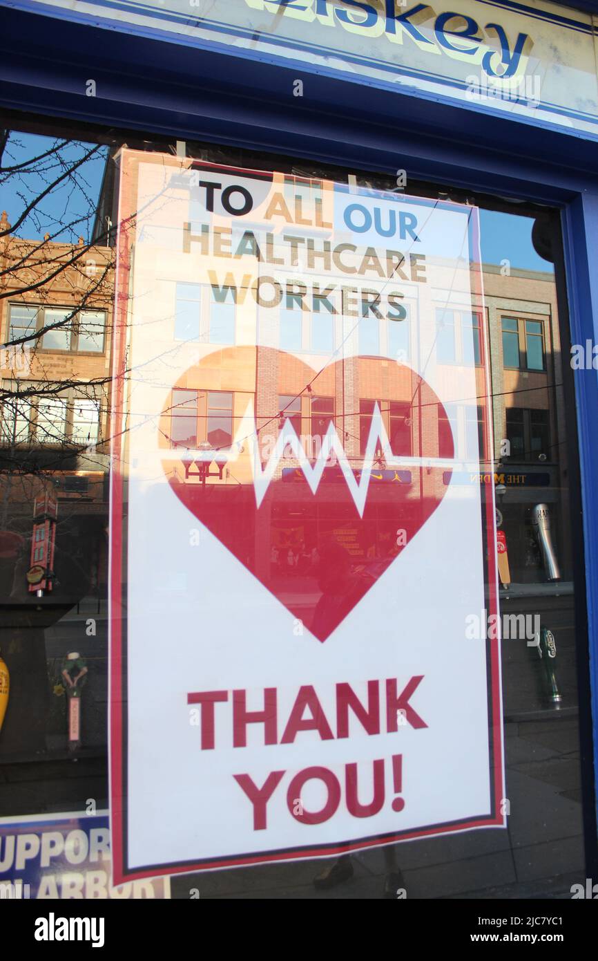 Ann Arbor Michigan United States thank you healthcare workers artwork sign in store window downtown ann arbor small businesses closed due to covid 19 Stock Photo