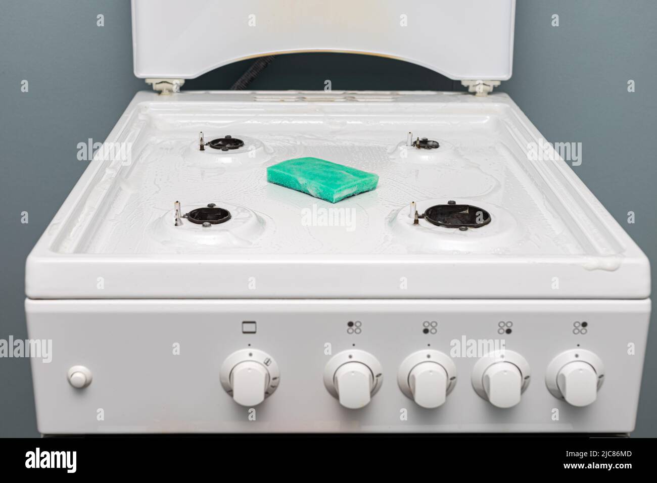 a rag and gel lie on the gas stove during cleaning. High quality photo