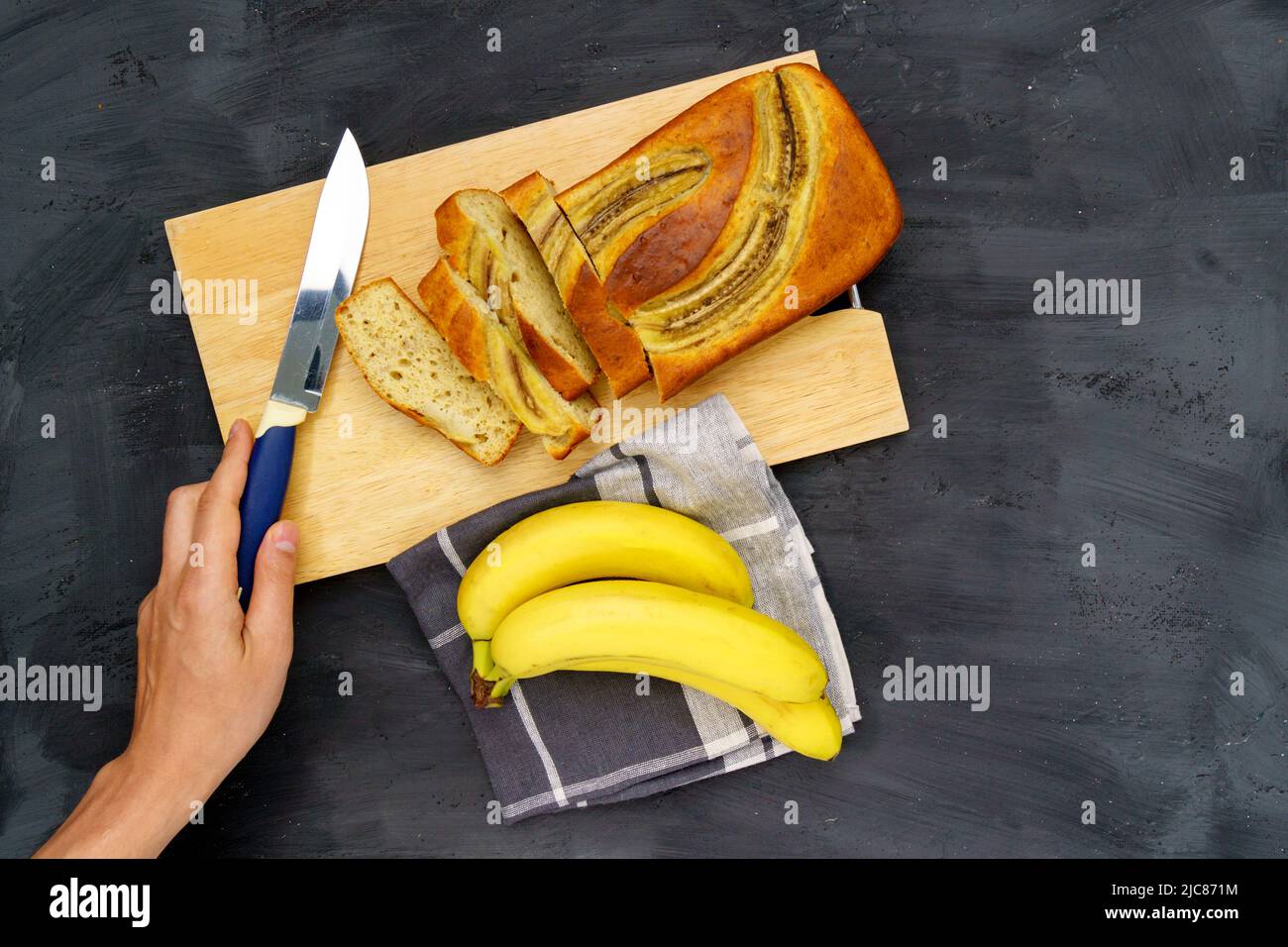 Baked banana bread, sliced on a cutting board. Bakery, cafe, home chef