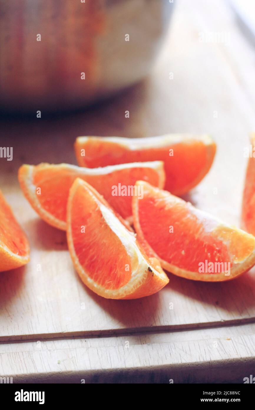 Orange wedges on a kitchen board Stock Photo - Alamy