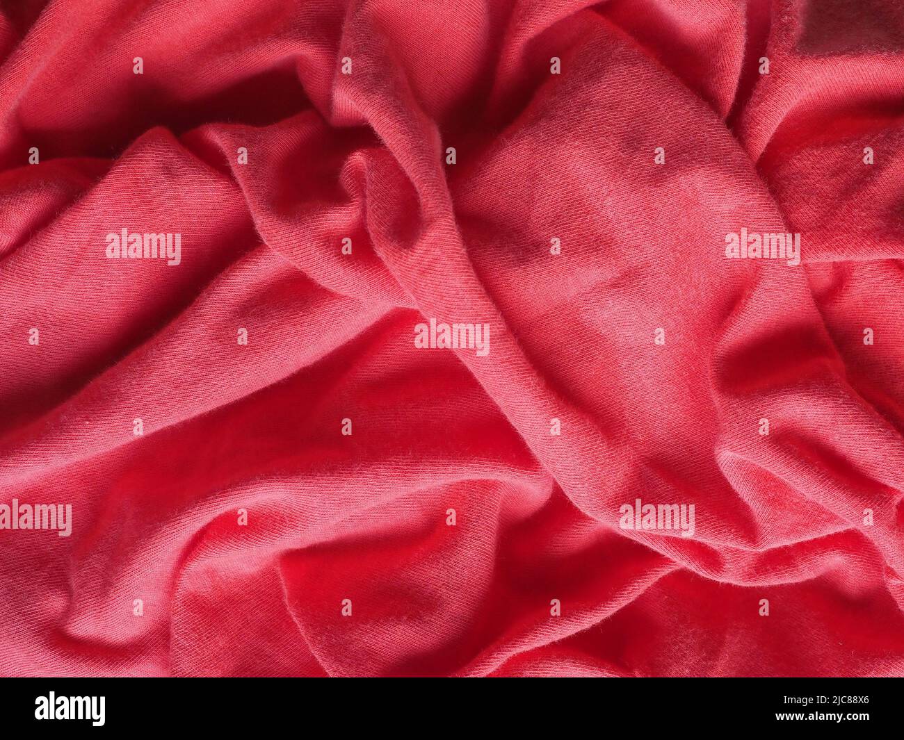 crumpled red fabric texture useful as a background Stock Photo