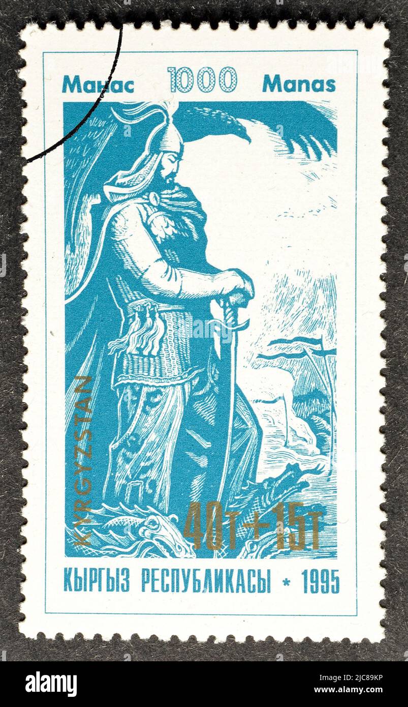 Cancelled postage stamp printed by  Kyrgyzstan, that shows Warrior looking at dead dragon, Millenary of Kirghiz Epic Poem 'Manas', circa 1995. Stock Photo