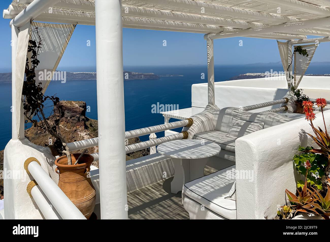 A bamboo canopy throws elegant shadow stripes on a terrace lounge in Imerovigli on Santorini island Stock Photo