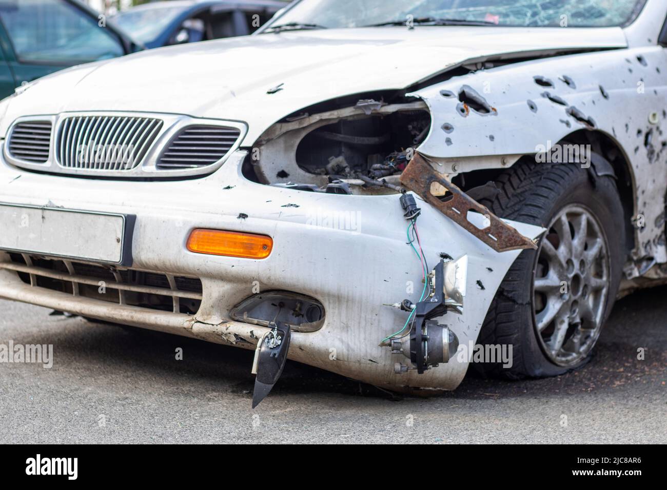 A car destroyed by shrapnel from a rocket that exploded nearby ...