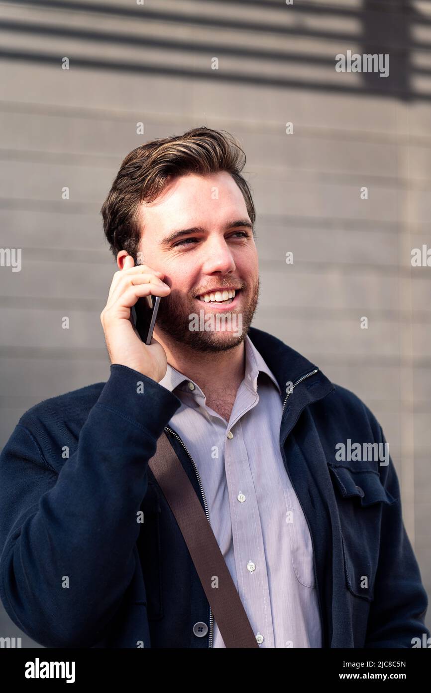 smiling man entrepreneur talking by phone Stock Photo