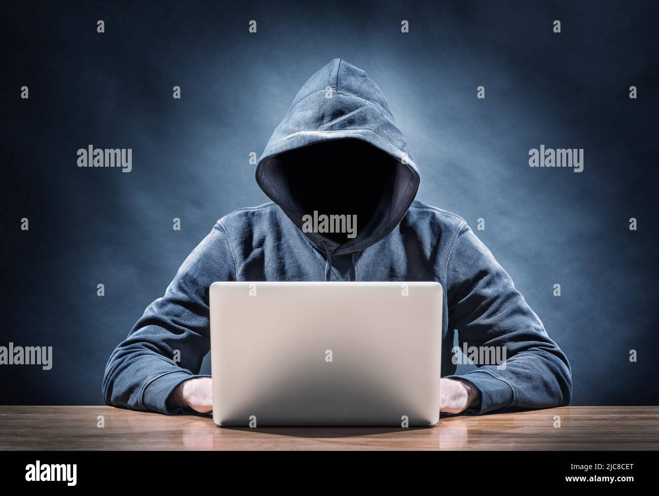 hacker on a laptop tries to steal a password Stock Photo