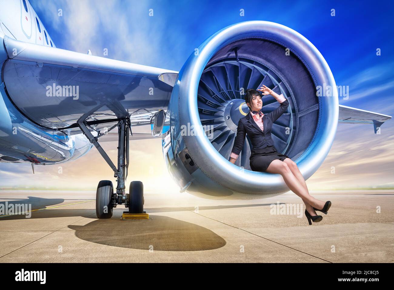 young stewardess sitting in a jet engine Stock Photo