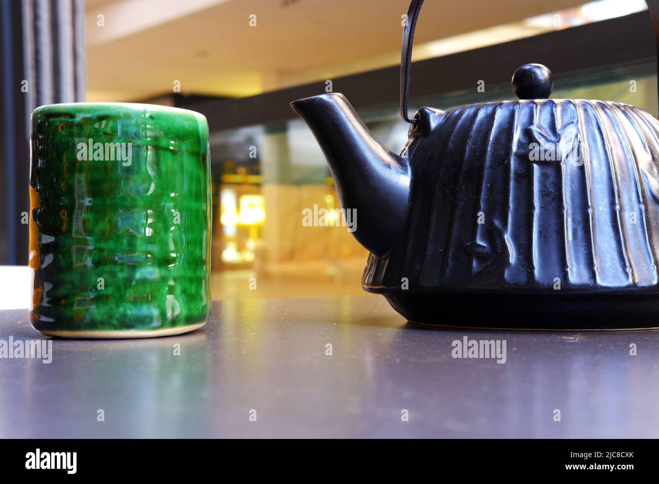 Chinese style vintage ceramic green tea mug and teapot on table Stock Photo