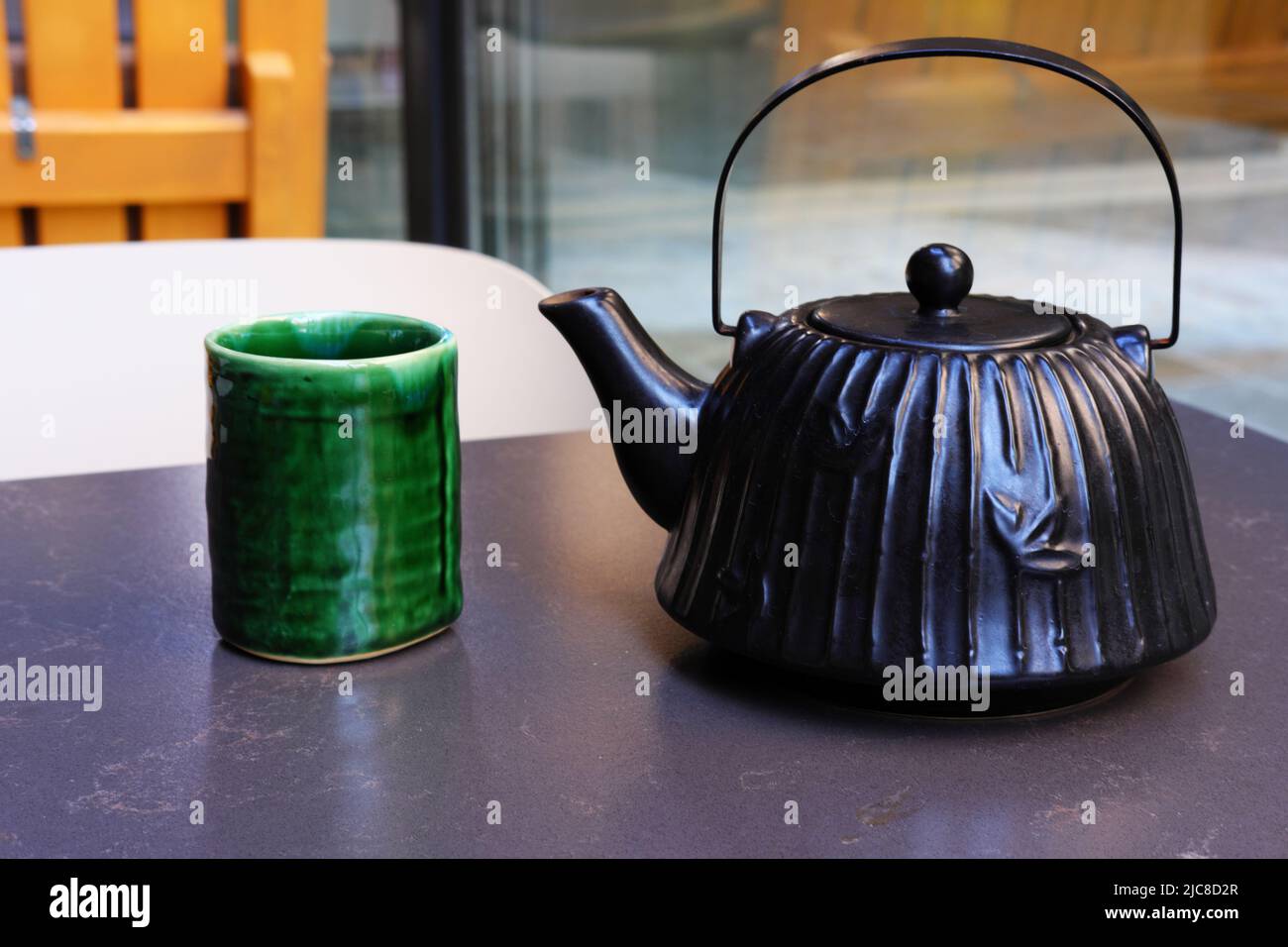 Chinese style vintage ceramic green tea mug and teapot on table Stock Photo