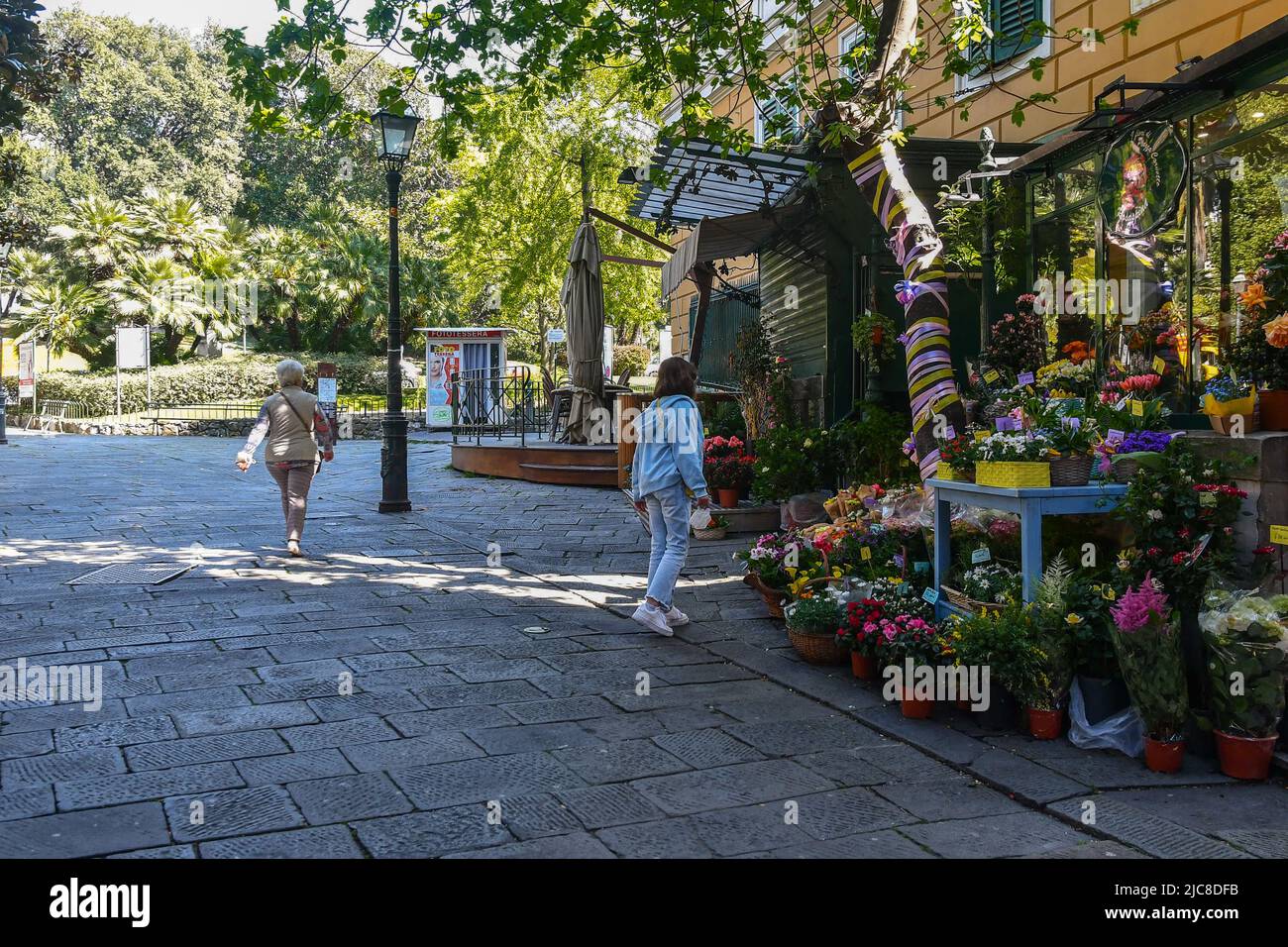 Exterior of a flower shop with blooming plants displayed on the sidewalk in Piazza Corvetto, Genoa, Liguria, Italy Stock Photo