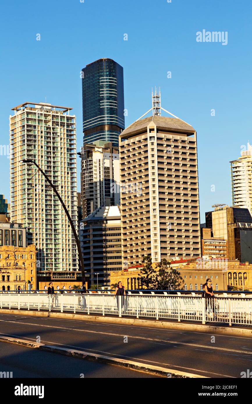 Brisbane Australia /  Pedestrians cross the Victoria Bridge with the modern Brisbane Skyline behind them. Stock Photo