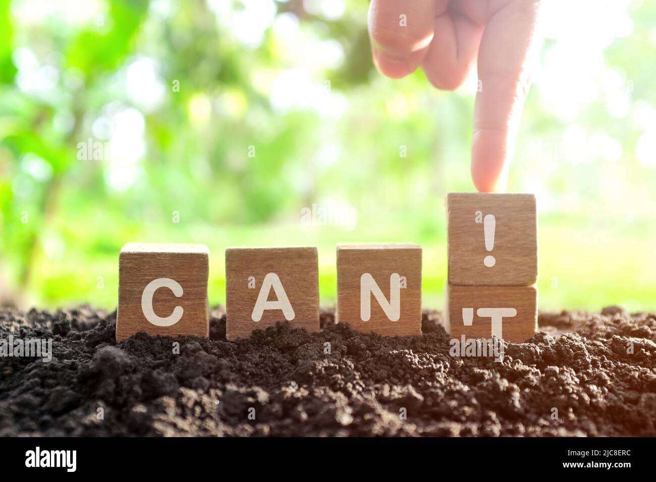 Self motivation and positive thinking concept. Hand changing wooden blocks letters from can't to can. Stock Photo