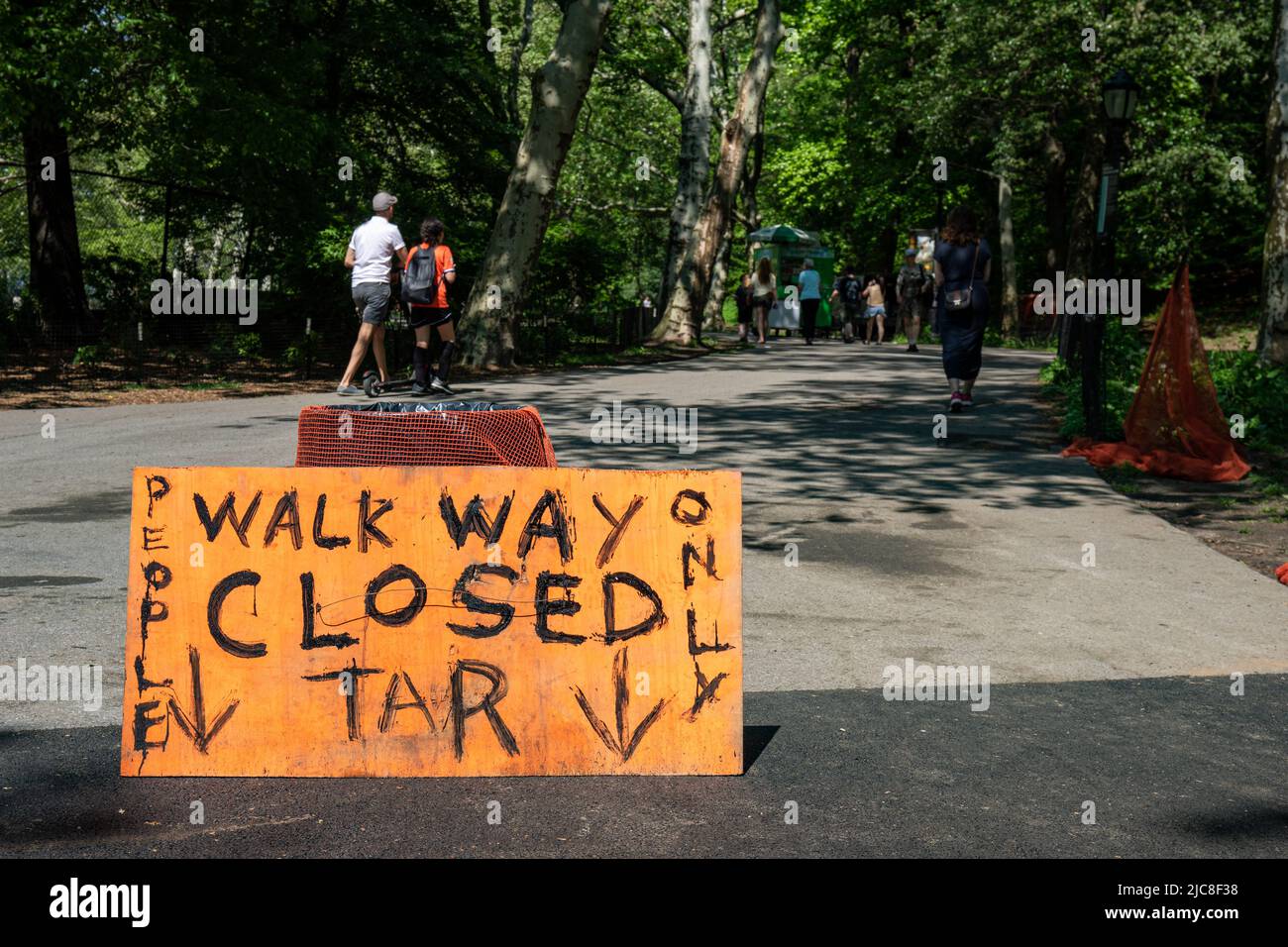 Closed walkway. Orange sign written with tar in Riverside Park in Upper West Side district of New York City, United States. Stock Photo