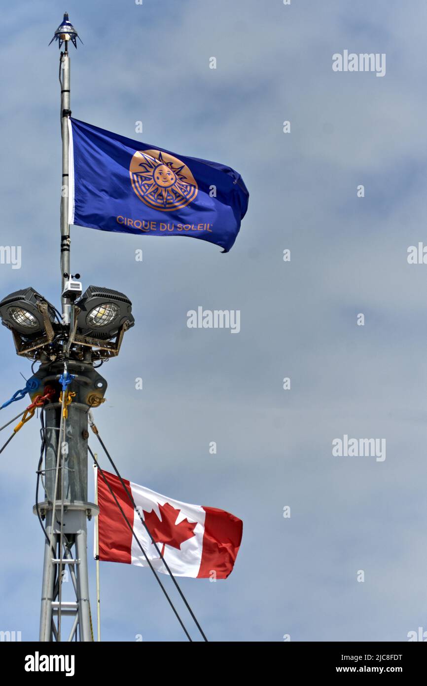 Geneva, Switzerland - may 28, 2022 : sign and logo on a flag at top of the tent of the Cirque du Soleil , a Canadian entertainment company circus prod Stock Photo