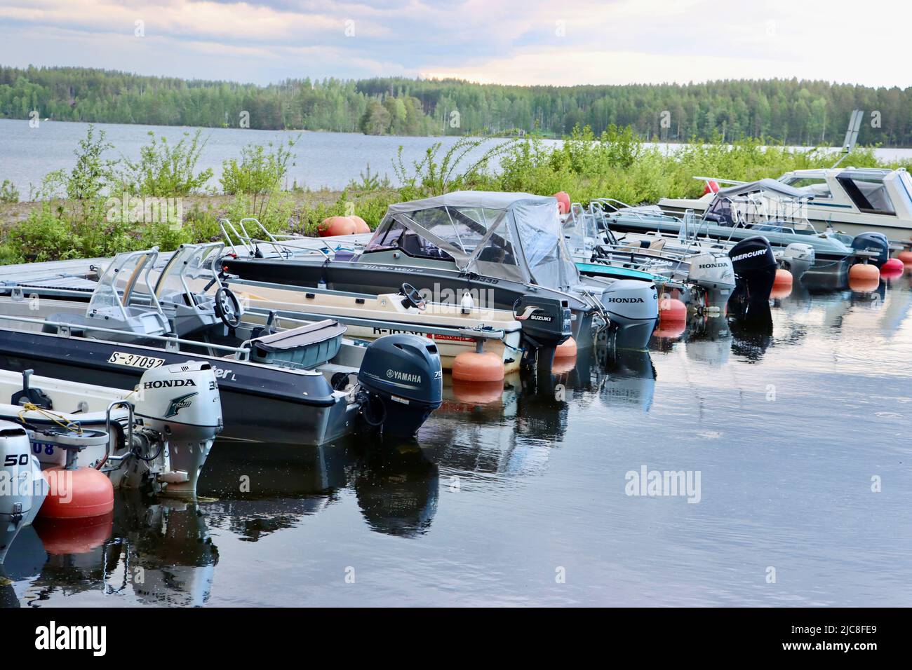 Boats of people with summer houses near the border zone on Lake Pyhäjärvi on the Finland side of the Finland-Russia borden Stock Photo