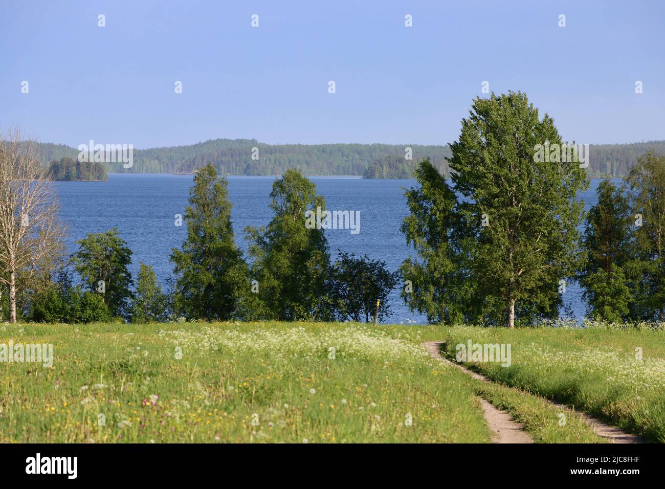 View over Lake Pyhäjärvi at Uukuniemi border zone on the Finland side of the Finland-Russia borden.  Russia on the far side of lake. Stock Photo