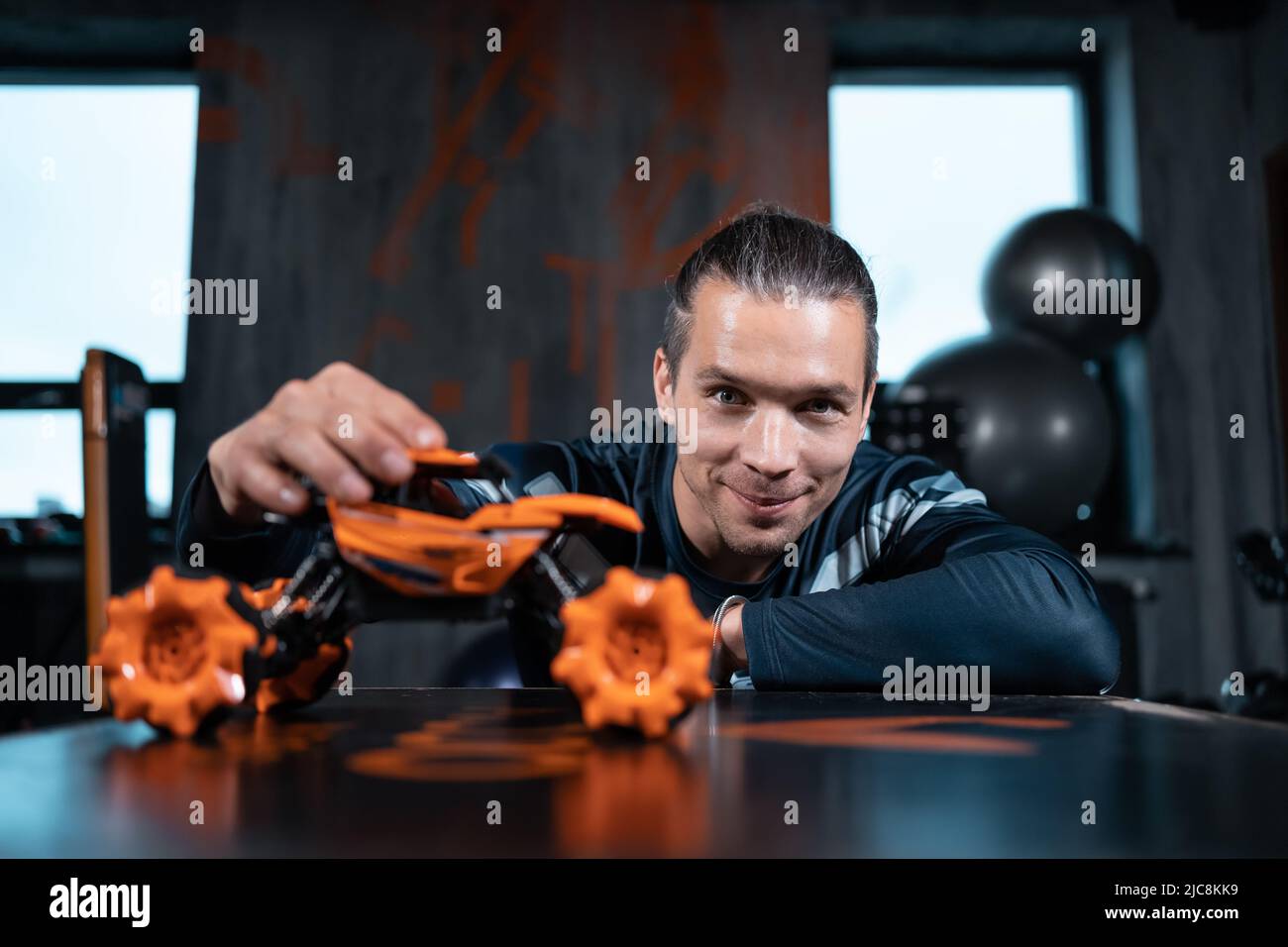 young man play with toy car and expressing inner child Stock Photo