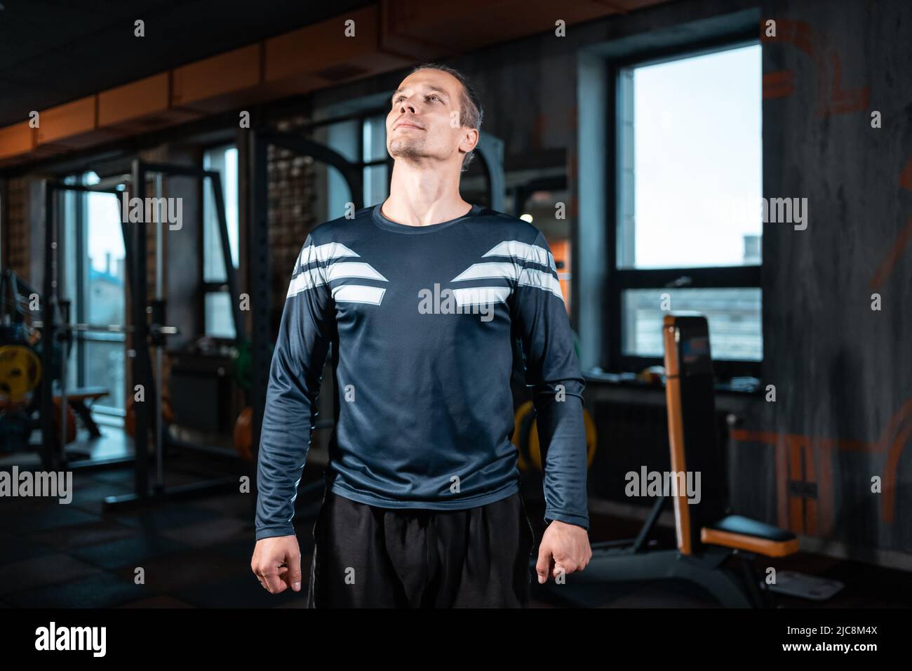 young attractive man personal trainer preparing workout in gym Stock Photo