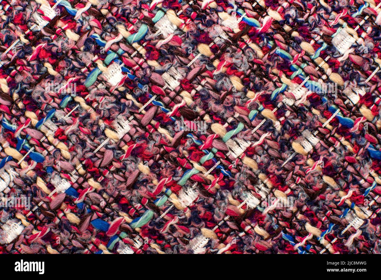 Texture of fabric from multi-colored threads for knitting. Fabric for tailoring. Colored thread pattern Stock Photo