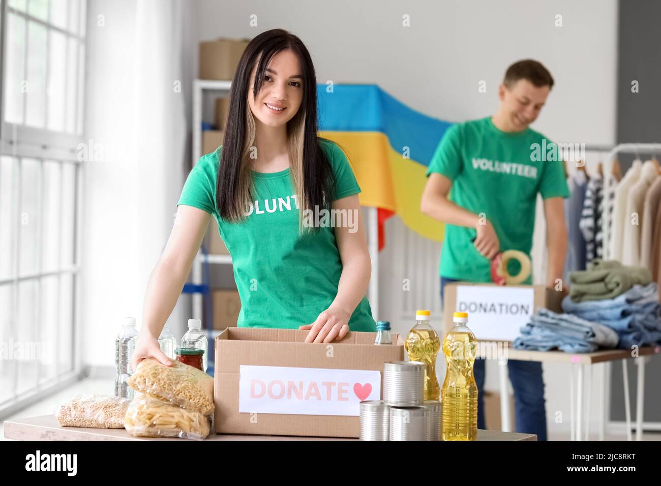 Polish volunteer putting food into donation box for Ukraine in center