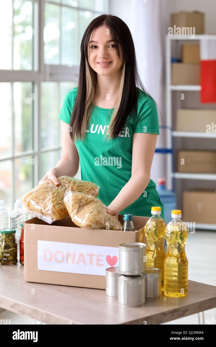 Polish volunteer putting food into donation box for Ukraine in center