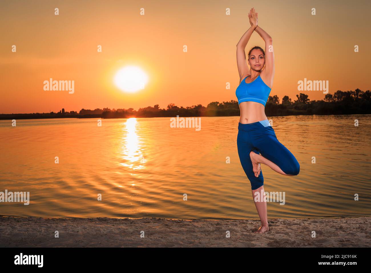 yoga at sunset on the beach Stock Photo - Alamy