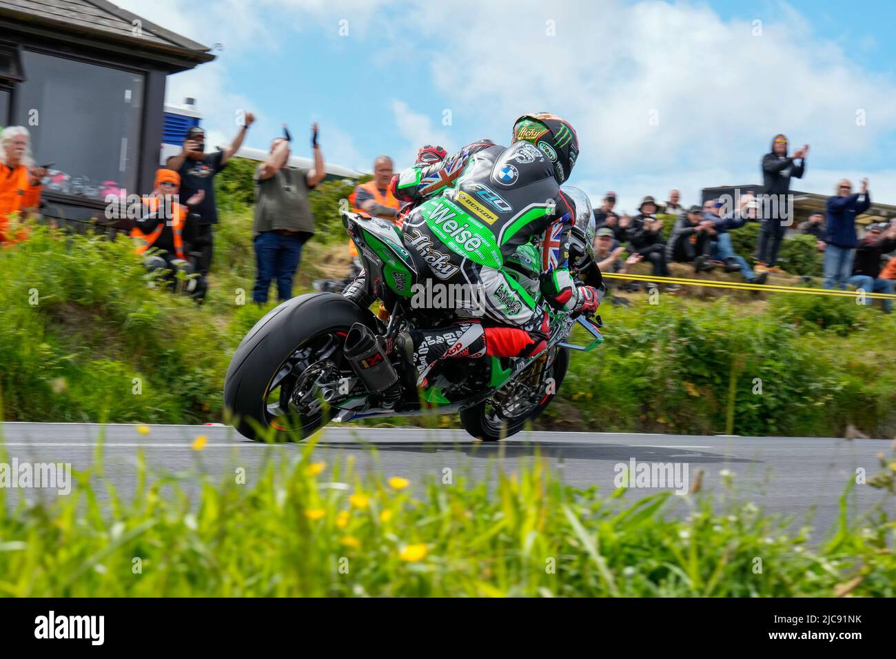Douglas, Isle Of Man. 11th June, 2022. Peter Hickman (1000 BMW) representing the Gas Monkey Garage by FHO Racing team waves to fans in the last lap of the 2022 Milwaukee Senior TT at the Isle of Man, Douglas, Isle of Man on the 11 June 2022. Photo by David Horn. Credit: PRiME Media Images/Alamy Live News Stock Photo