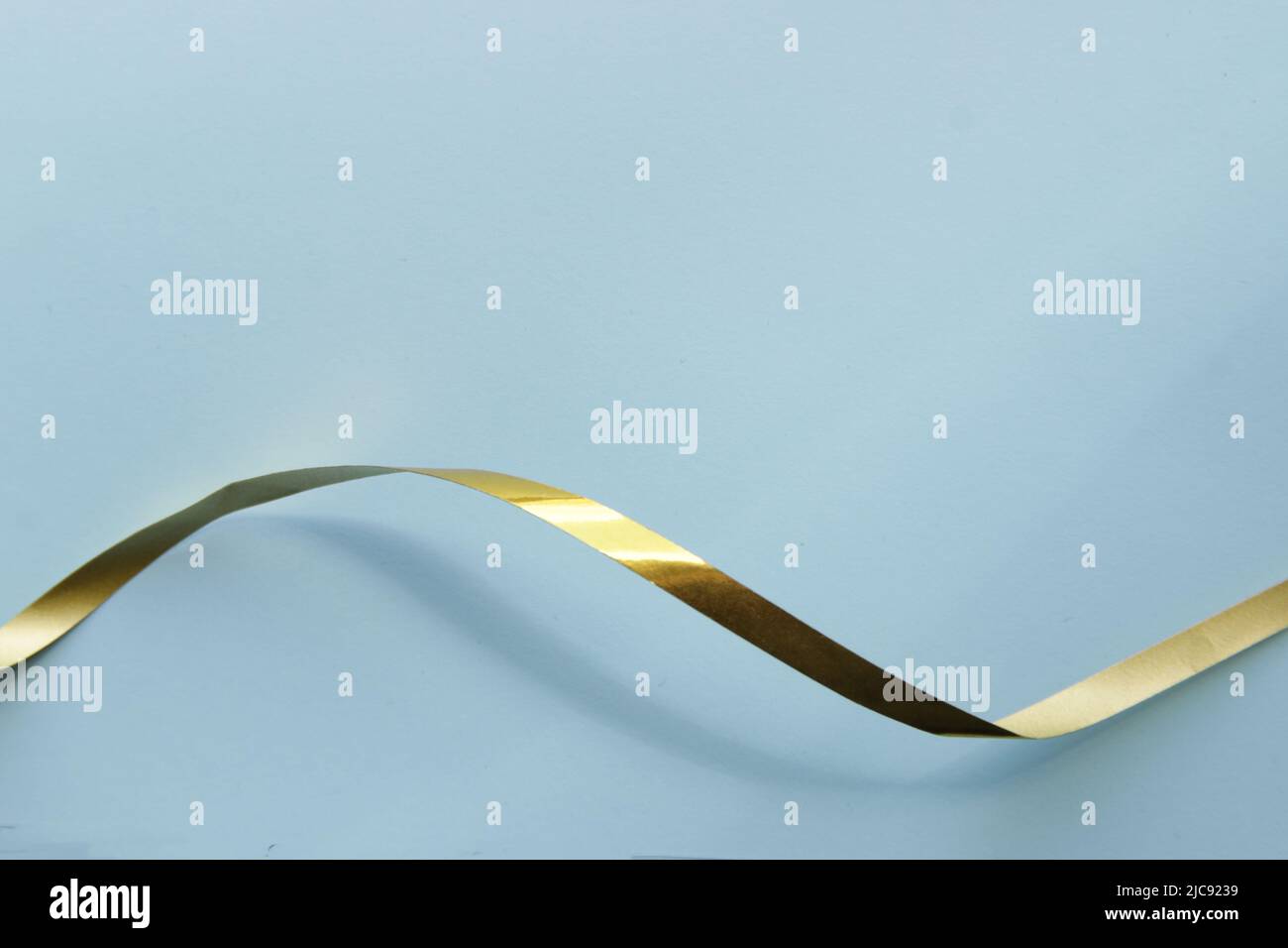 Ribbon on a paper background. Background for a greeting card. Stock Photo
