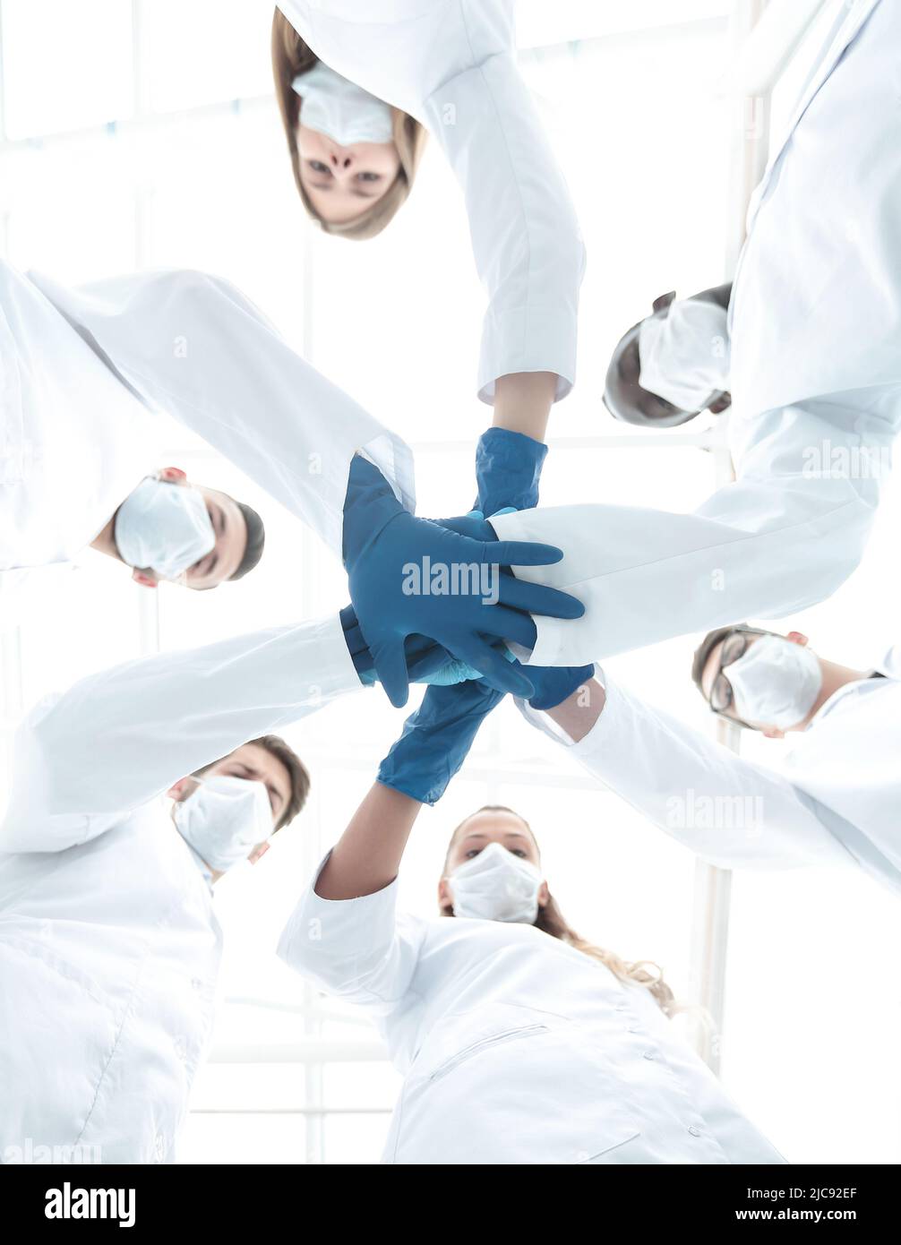 Doctors and nurses in a medical team stacking hands Stock Photo