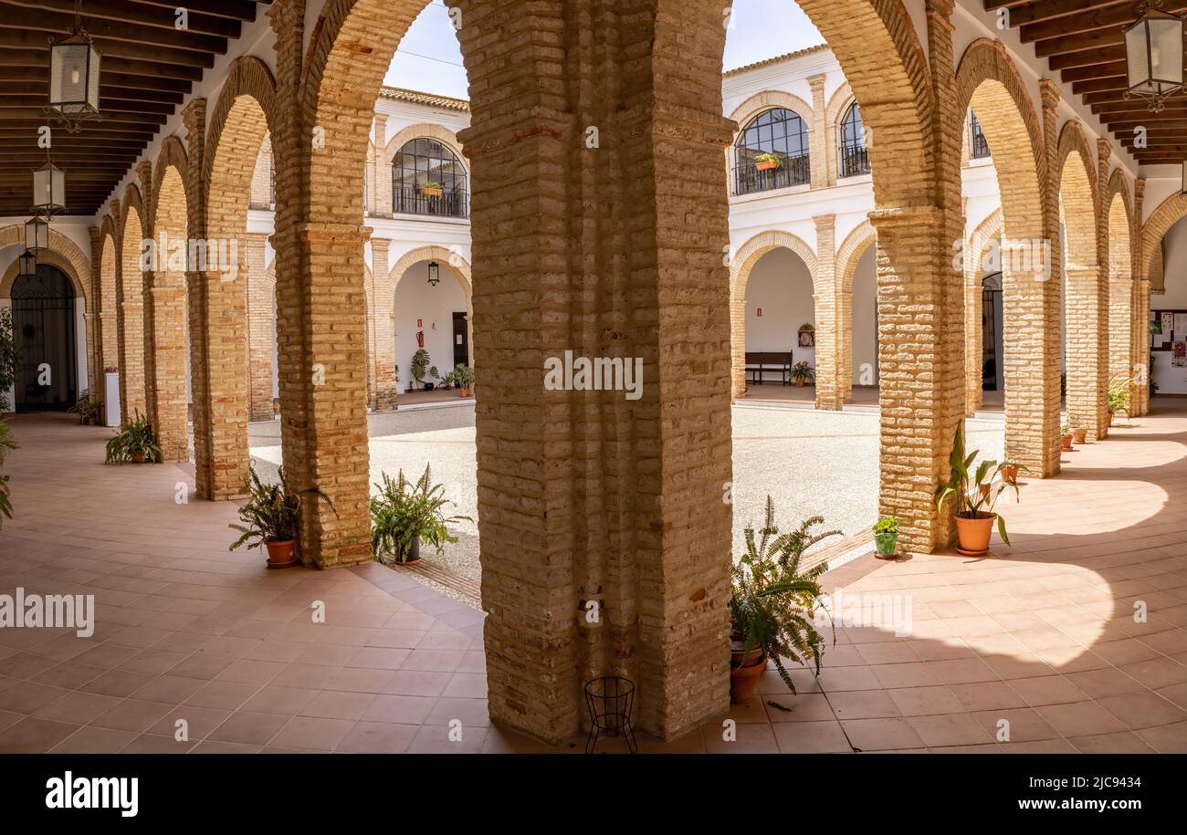 Trigueros, Huelva, Spain - April 17, 2022: Courtyard of El Convento del Carmen, former Consolación convent occupied by Carmelite religious, has its or Stock Photo