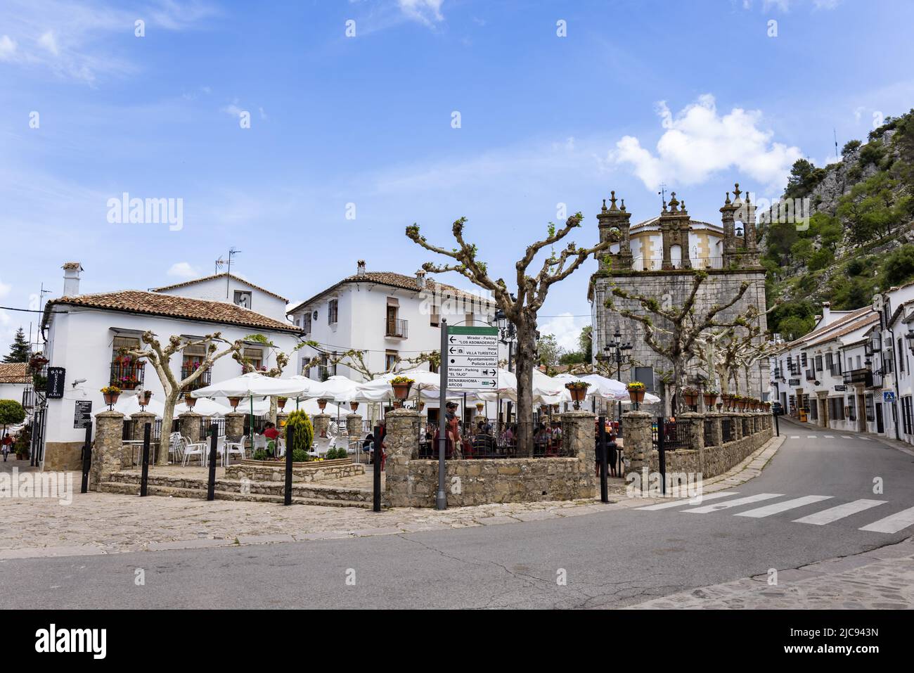 Grazalema, Cadiz, Spain - May 1, 2022: Main square with bar terraces of Grazalema village, (Grazalema mountains), one of the villages of the route of Stock Photo