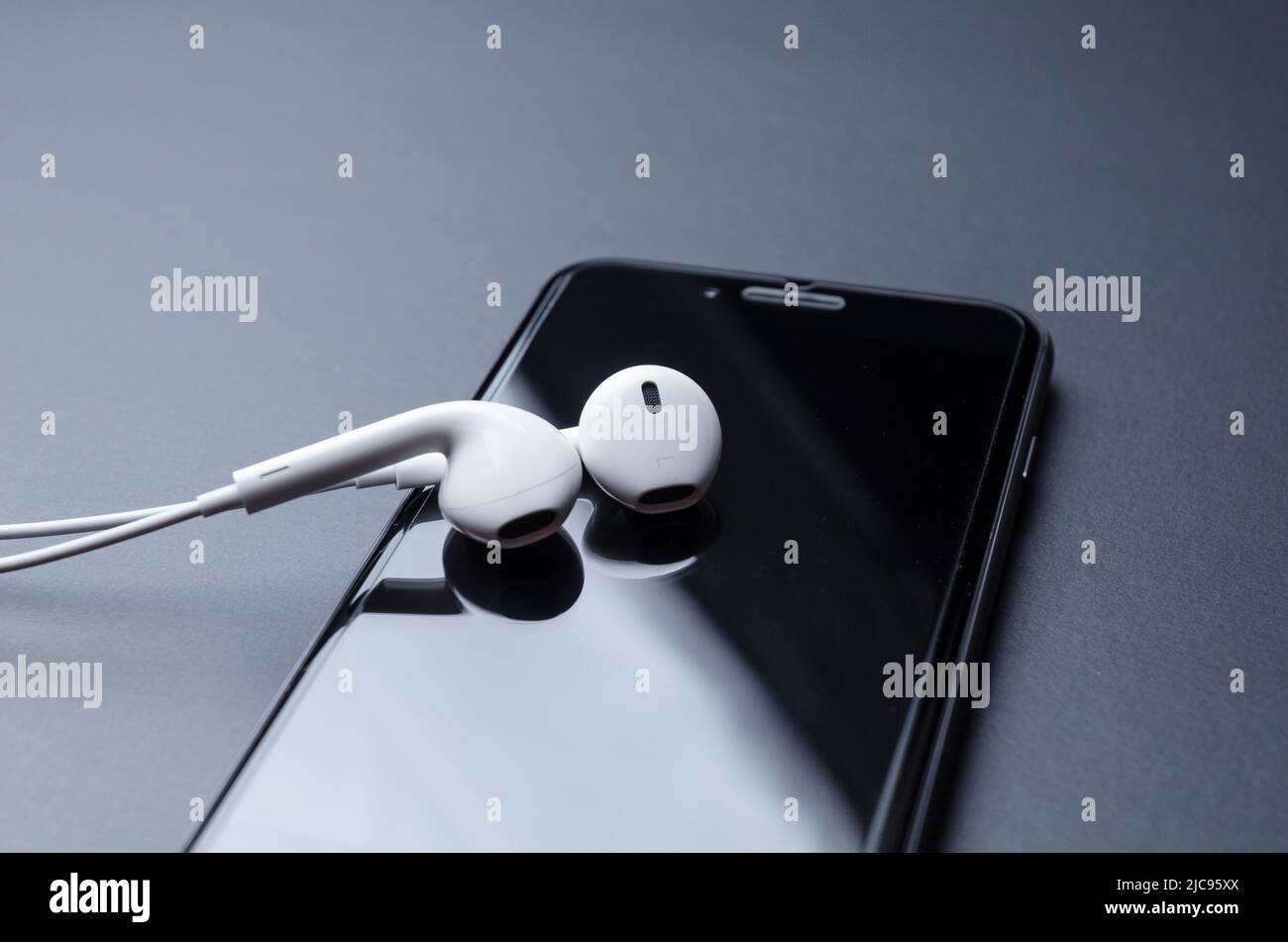 Apple iPhone 8 smartphone with EarPods on dark grey background Stock Photo  - Alamy