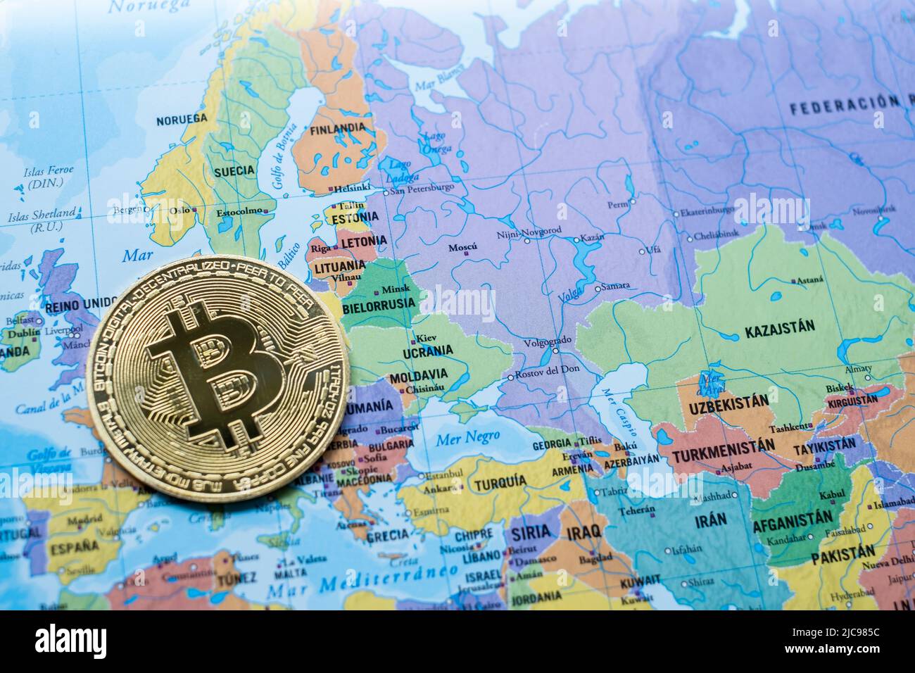 a bitcoin currency on a political map Europe and Asia, next to Ukraine, use of cryptocurrency, aid to the Ukrainian war, economic power Stock Photo