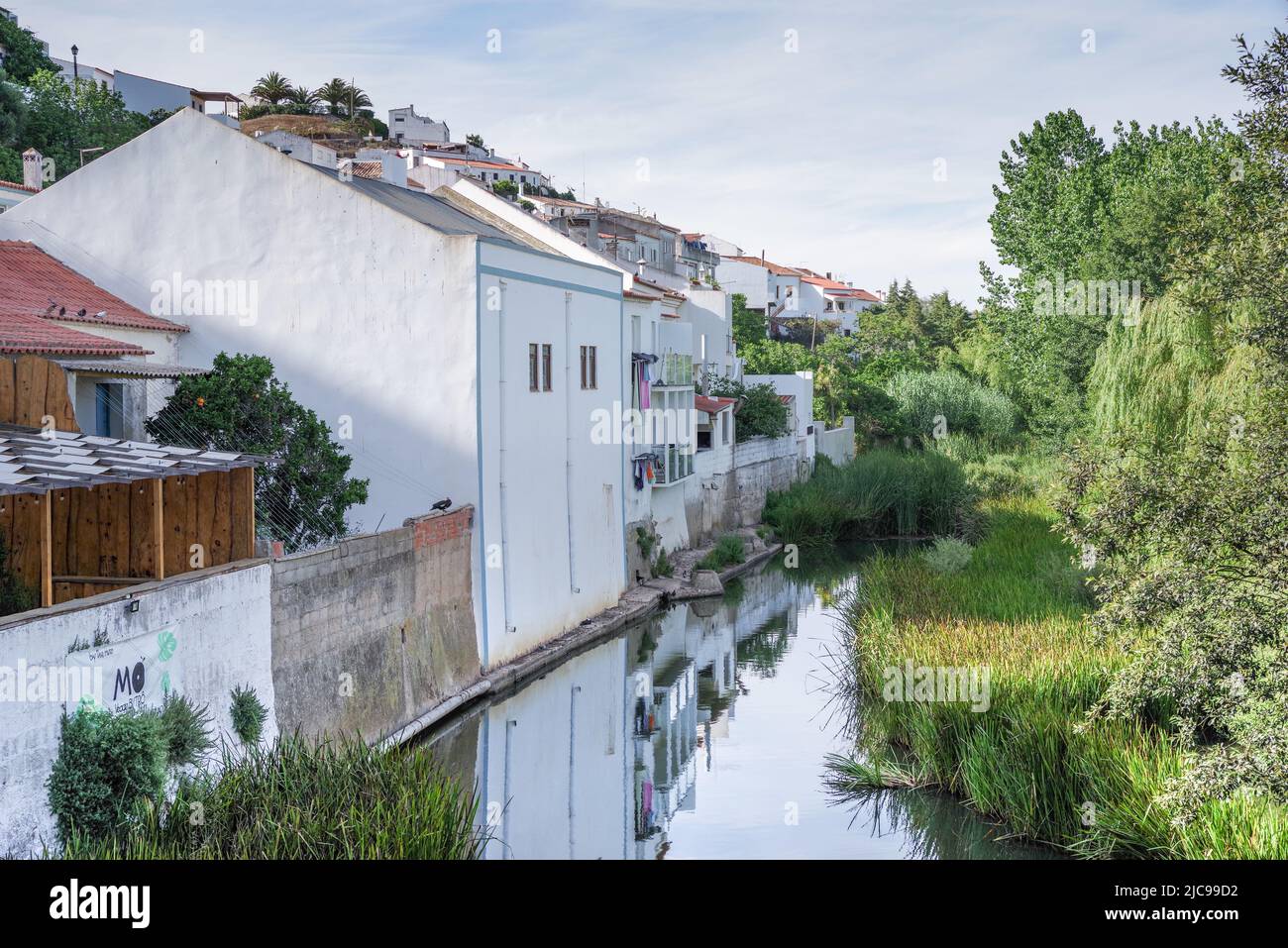 Houses reflected in the calm waters of Aljezur River - Aljezur (Algarve, Portugal) Stock Photo