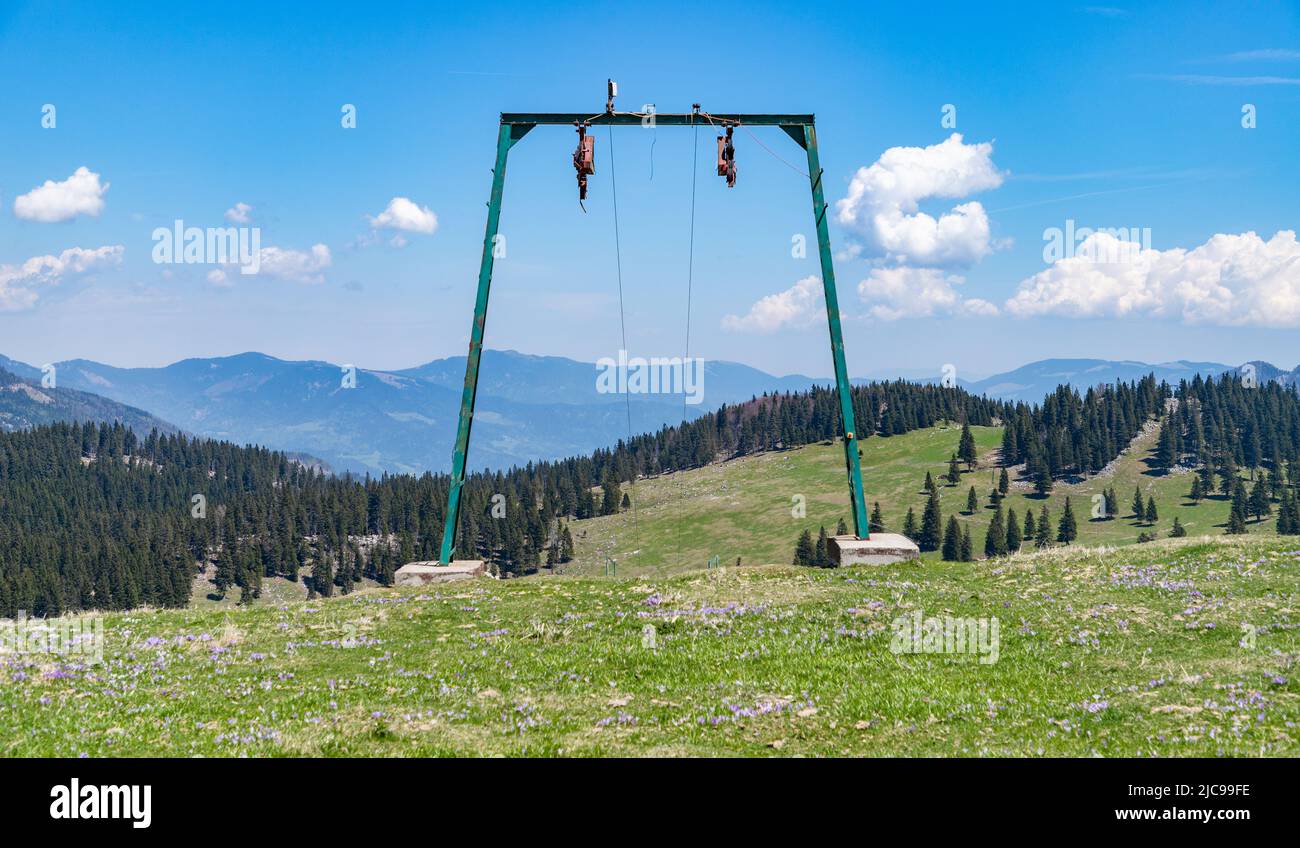 A picture of the landscape of Velika Planina, or Big Pasture Plateau, as seen through a ski lift small tower. Stock Photo