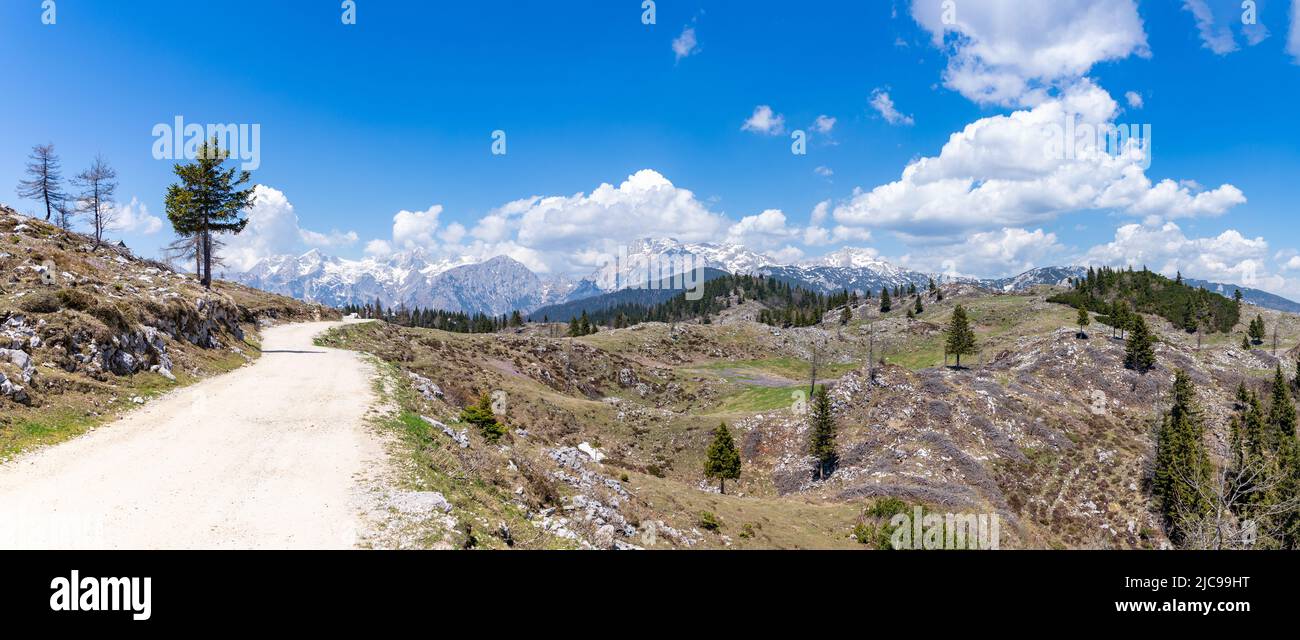A picture of the landscape of Velika Planina, or Big Pasture Plateau, with the Kamnik–Savinja Alps on the background. Stock Photo