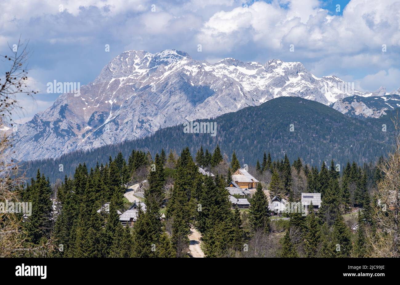 A picture of the landscape of Velika Planina, or Big Pasture Plateau, and its herder huts, with the Kamnik–Savinja Alps on the background. Stock Photo