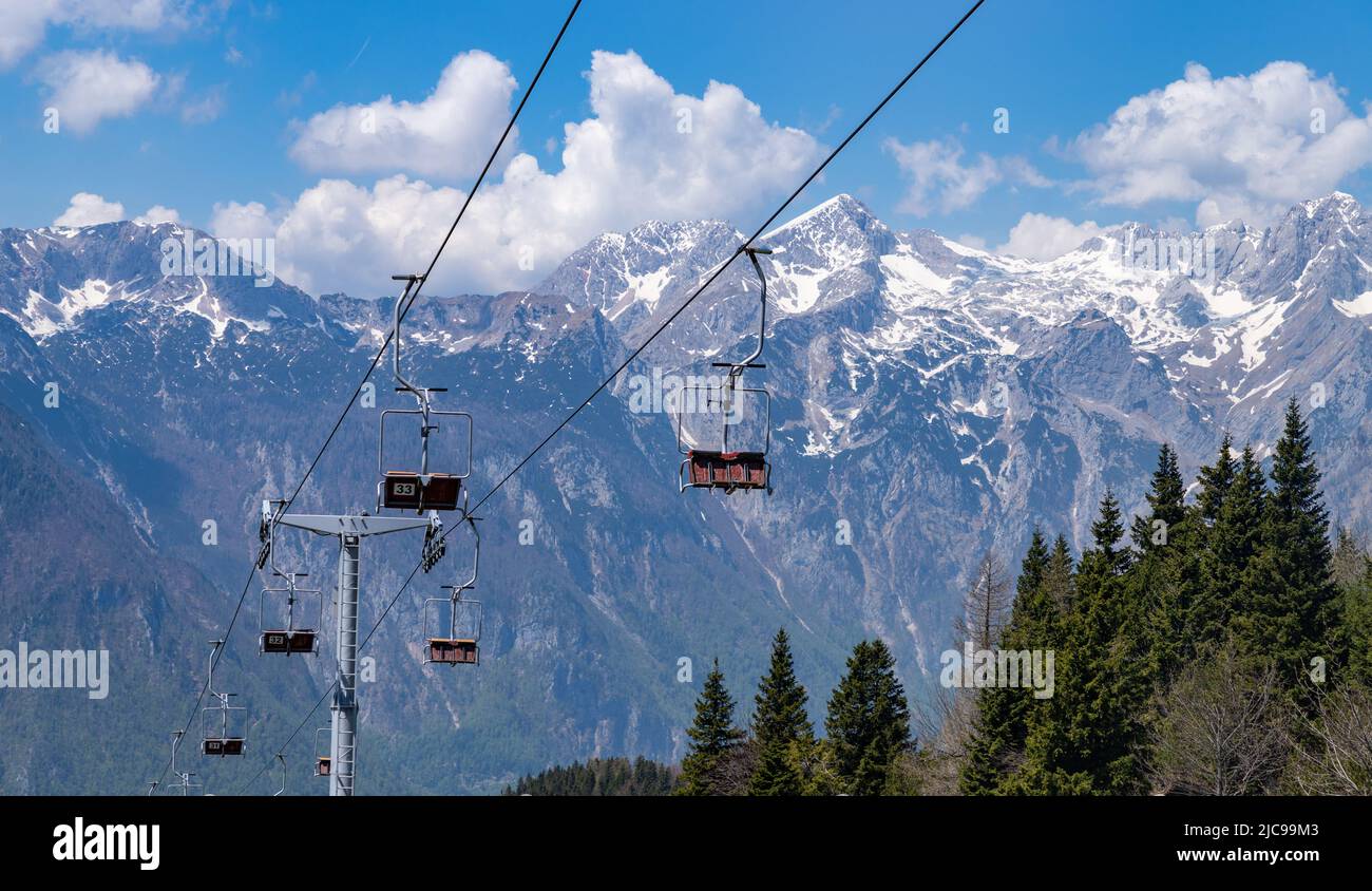 A picture of the Kamnik–Savinja Alps on the background of the Velika Planina's ski lifts. Stock Photo