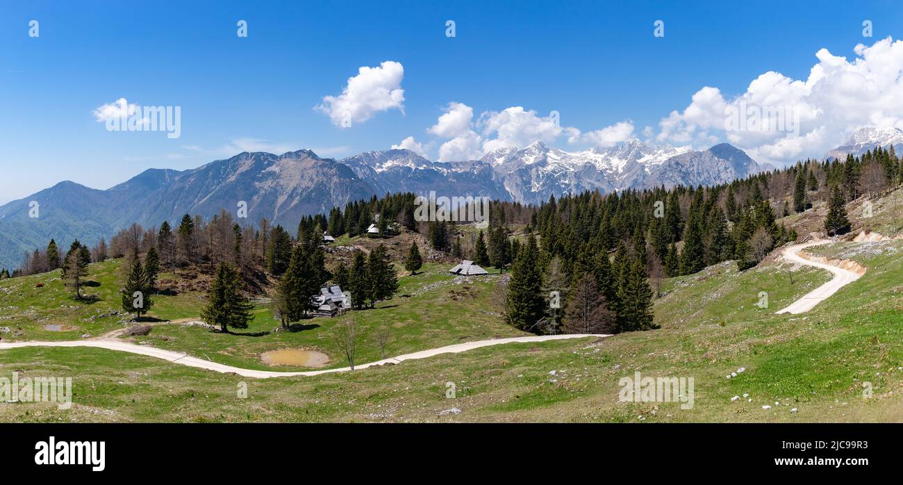 A picture of the landscape of Velika Planina, or Big Pasture Plateau, with the Kamnik–Savinja Alps on the background. Stock Photo