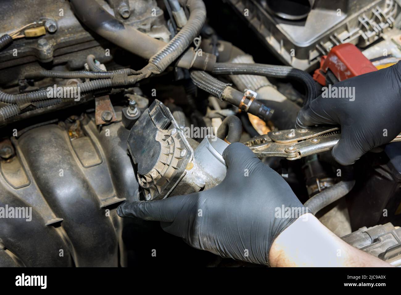 Mechanic replacement throttle body of car engine Stock Photo Alamy