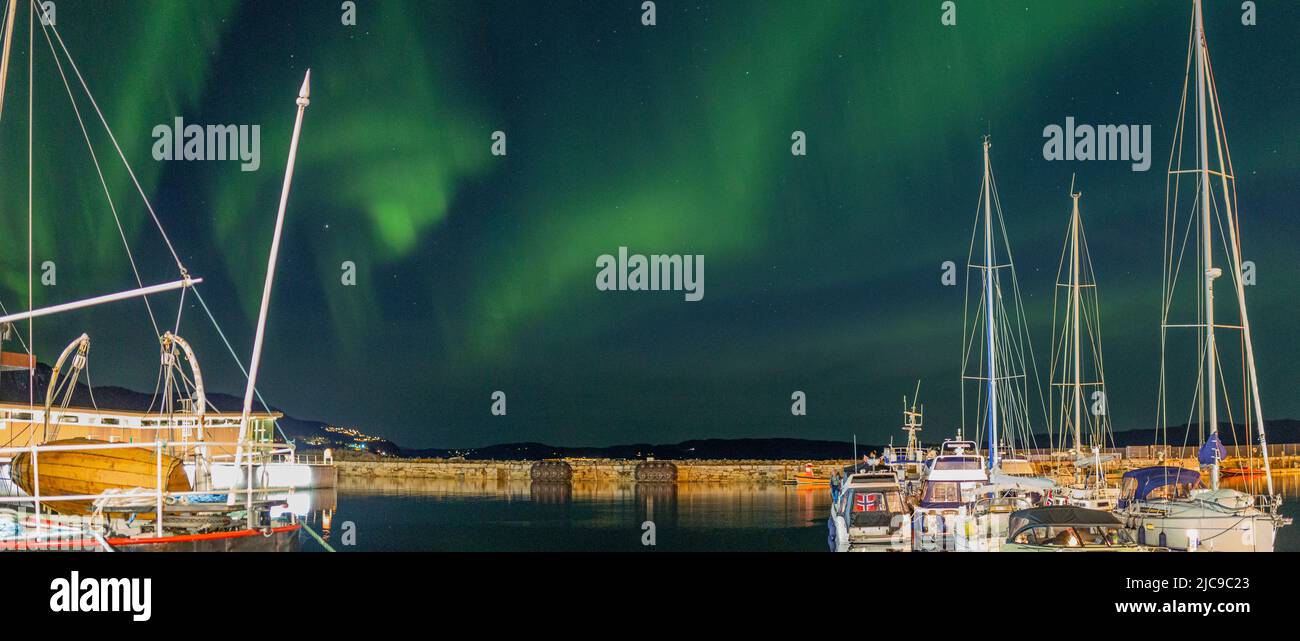 Polar Lights over Trondheim reflecting in the Harbour. Stock Photo