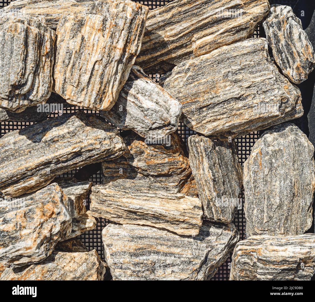 Decorative stones. Many small stones of rough structure, gray black