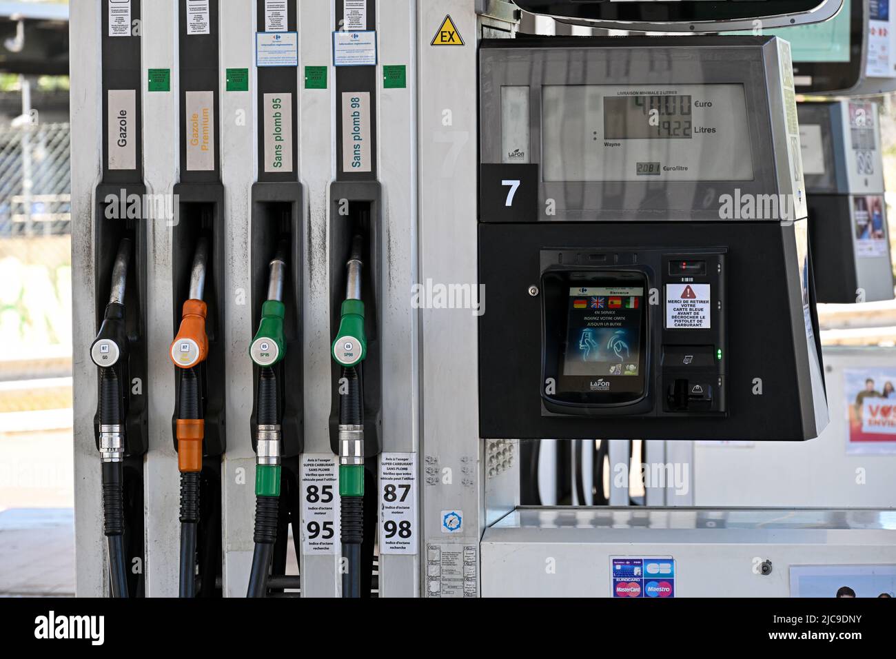 People pump their gas at an Esso gas station in Cannes, France on June