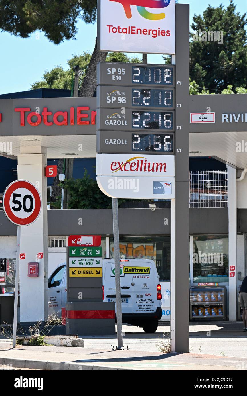 People pump their gas at an Esso gas station in Cannes, France on June