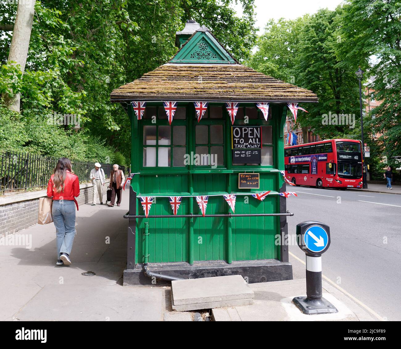 London, Greater London, England, May 28 2022: Green Cabmen Shelter aka Cabbie Shelter with Union Jack bunting in Kensington. Stock Photo