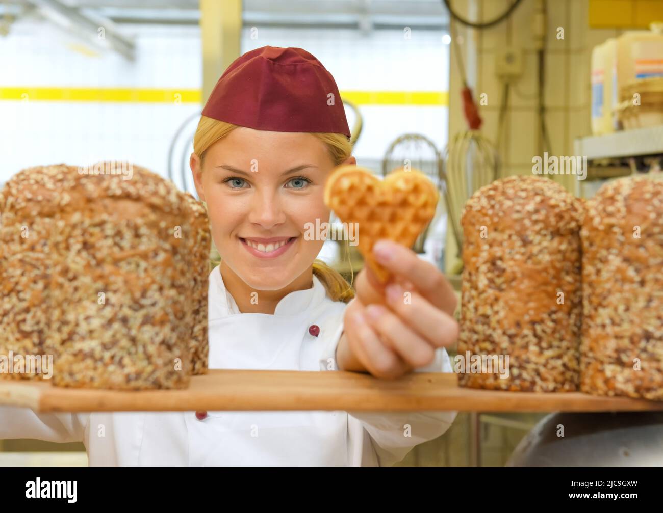 A young baker girl takes up her work in a bakery. She is seen in the