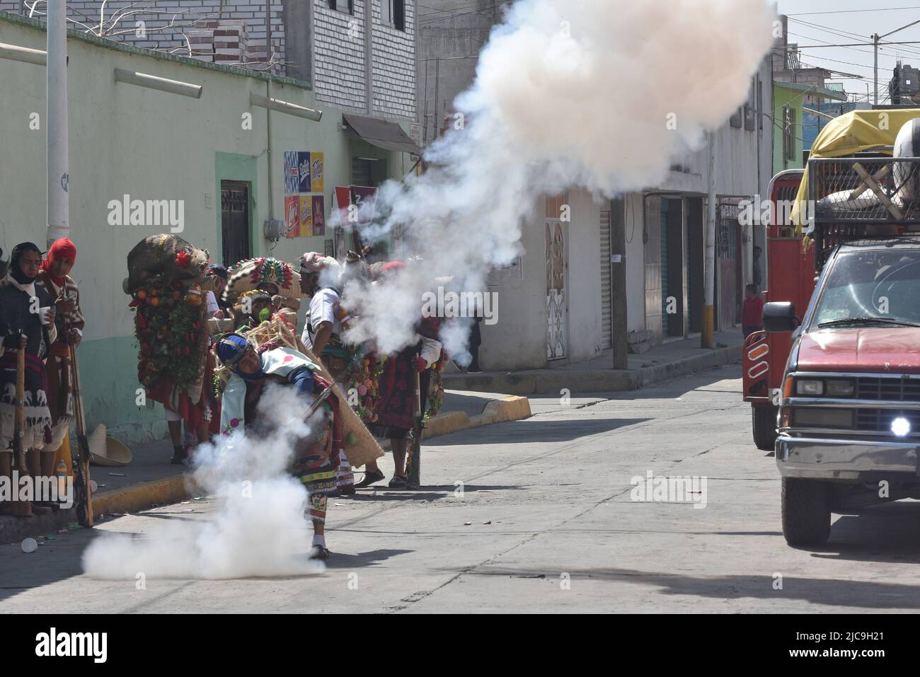 Firing a rifle during carnval in Carnaval in Huejotzingo, Puebla Mexico Stock Photo