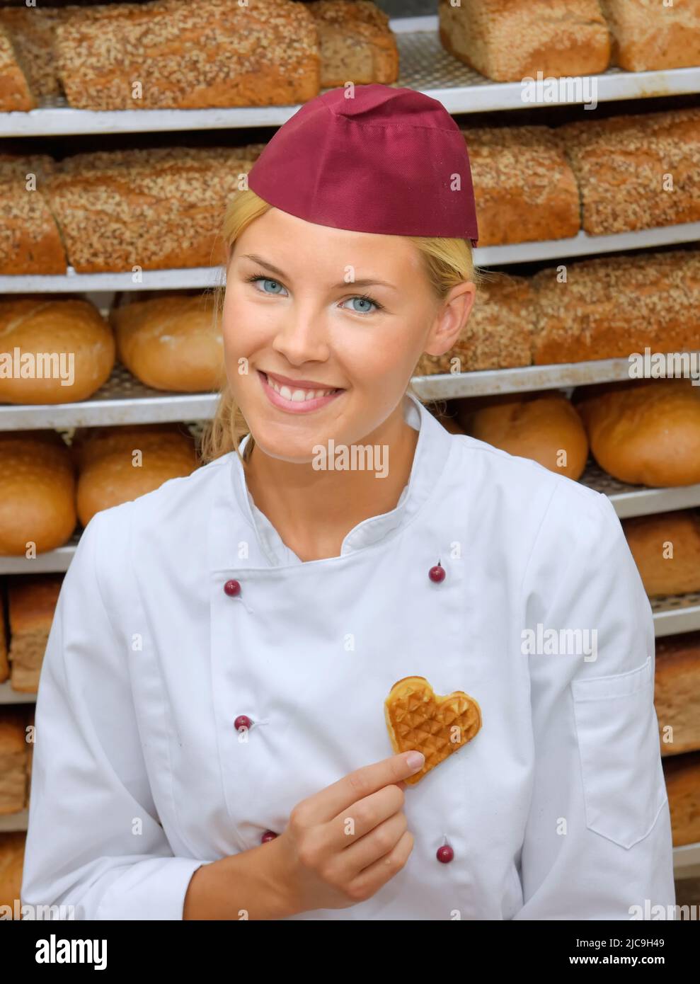 A young baker girl takes up her work in a bakery. She is seen in the